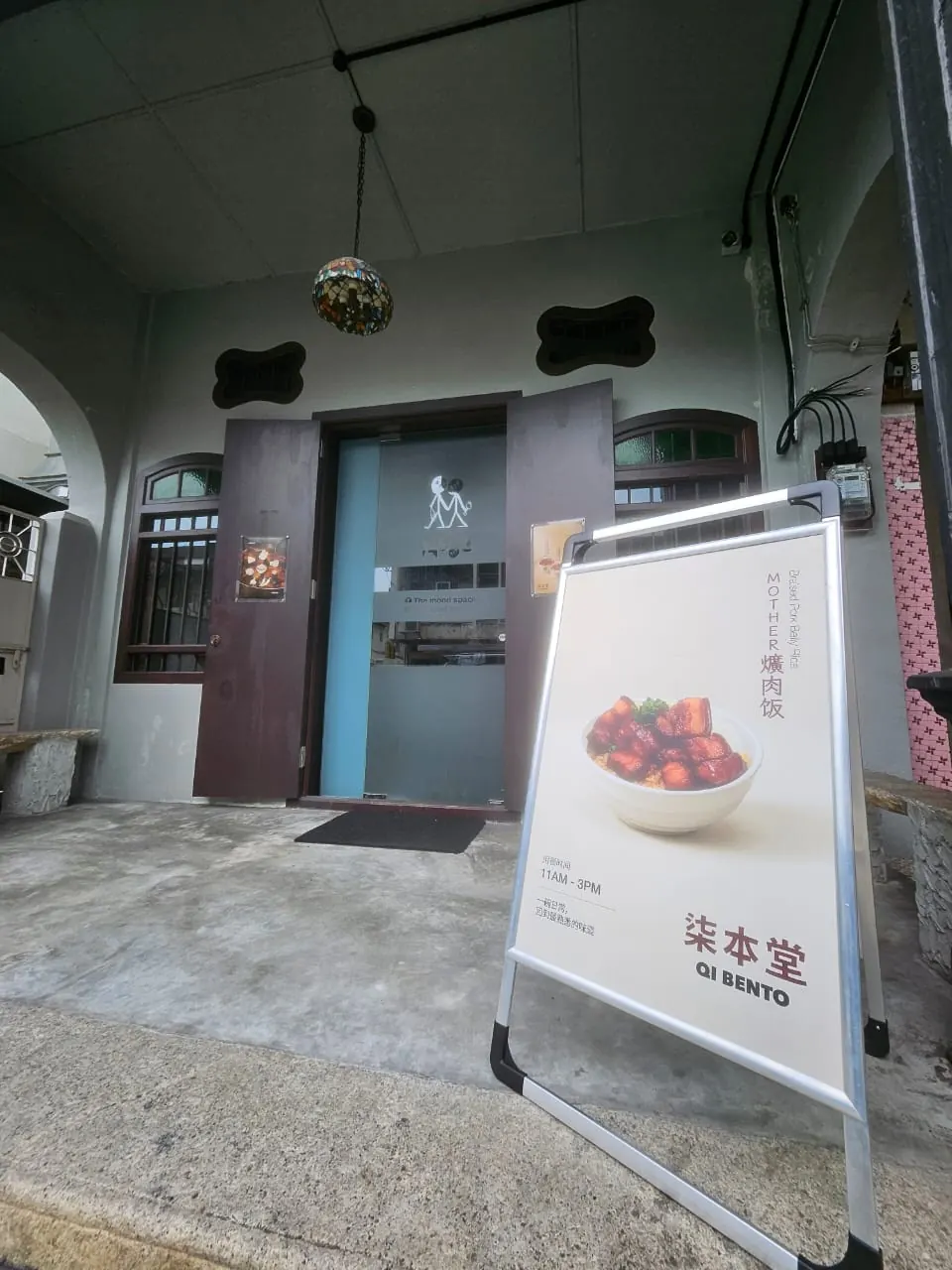 Qi Bento braised pork rice promotional sign outside MOOD, George Town, Penang